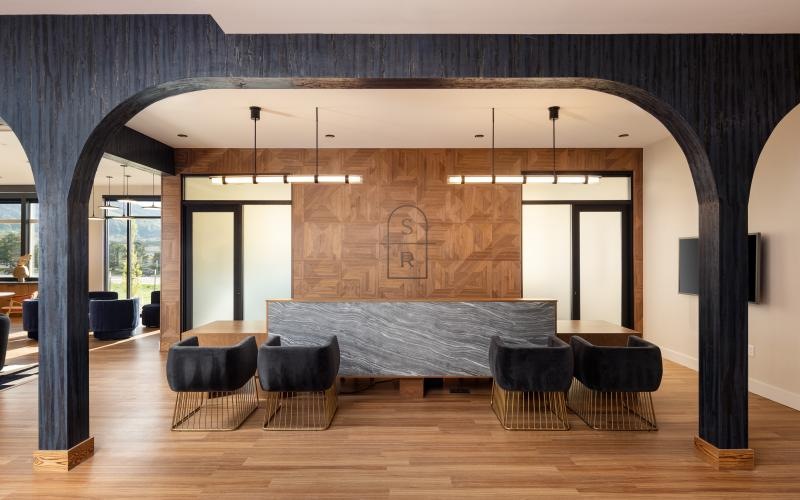 Lobby with modern seating and wooden accents in our luxury apartments in Littleton, CO.